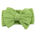 Grass green knitted baby headband featuring a large jacquard textured bow for infants - Grass Green