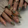 Close-up of long almond nails featuring green snakeskin patterns and 3D gold fluid metal art - Snake Print Metallic Line Star Style (XL-102-33)