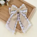 Detail of elegant double-layered lace bow hair clip with satin ribbon and floral trim - Khaki