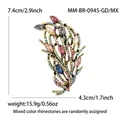 Golden feather brooch with colorful rhinestones in blue, pink, and amber tones - Antique Gold Multi-color