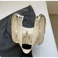Chic cream white hobo bag with utilitarian front pockets and silver eyelet strap detail - Off White