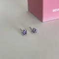 Silver stud earrings featuring two sparkling purple heart-shaped cubic zirconia - Purple