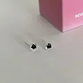 Silver-tone heart stud earrings featuring black zircon stones and textured metal finish - Black