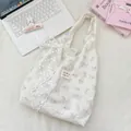 Detailed close-up of blue cat print canvas tote bag with large white lace bow - White Cat Print With White Flower