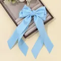 Detail of light blue bow hair clip with long streamers and zigzag edge trim - Dark Blue