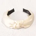Elegant ivory knotted headband with silky satin finish and black anti-slip lining - Cream