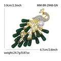 Elegant gold peacock brooch featuring green enamel, white crystals and a large faux pearl - Green