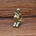 Macro shot of a vintage brass female figurine sculpture on a textured wooden desk - Black Stockings Beauty