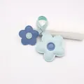 Close-up of blue leather flower charms with contrasting centers and visible white stitching - Blue