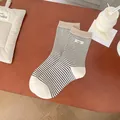 Striped mid-calf cotton socks in cream with black stripes and brown ribbed cuffs - White