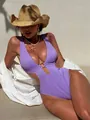 Detail of purple ribbed one-piece swimsuit with deep V-neck and golden ring hardware - S / Purple