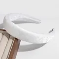 Serre-tête rembourré blanc avec broderie florale posé sur une boîte à bijoux - Imprimé Fleur Blanche
