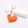 Detail of handmade orange leather heart keychain with white bow and silver metal ring - Orange