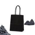 Black kraft paper gift bag with twisted handles and a serrated top edge design - Black
