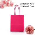 Peach pink thick white kraft paper bag with matching twist handles and floral accent - Hot Pink