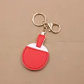Detail of candy-colored leather table tennis racket keychain with golden metal clasp - Table Tennis Racket Style / Red