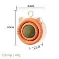 Orange catnip spinning ball toy in white cat-shaped frame, dimensions 5.5x6.9x3.1cm - Orange Yellow - Catnip Style