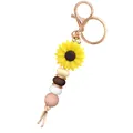 Macro detail of sunflower keychain with silicone beads and rose gold lobster clasp - Yellow