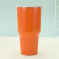 Close-up of a 30oz orange stainless steel insulated travel mug with transparent lid - Orange