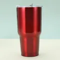 Detail view of deep red metallic finish 30oz tumbler with clear lid and tapered base - Red