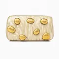 Detailed close-up of ivory marble acrylic clutch with gold pebble metal decorations - Apricot