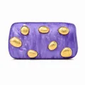Detailed macro of a purple marble acrylic clutch bag with gold stone-shaped metal accents - Purple