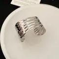 Brede zilveren manchetarmband met golvende metaaltextuur en modern ontwerp - Armring-Golfstijl / Zilver
