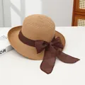 Beige straw sun hat with large dark brown fabric bow for beach and summer travel - Hollow Upturned Edge Khaki