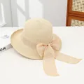 Elegant beige straw sun hat featuring a wide brim and textured bow ribbon detail - Hollowed-out Beige With Curled Edges