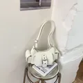 Detail view of cream multi-pocket utility shoulder bag with silver buckle accents - No Pendant / White