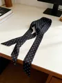 Polka dot 100% silk skinny scarf in black and blue on a minimalist white desk - Ink Blue Polka Dot