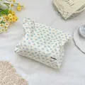Detail der floralen Cord-Kosmetiktasche Textur mit Markenetikett und Reißverschluss - Blaue Pfirsichblüte