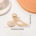 Elegant amber translucent bow hair claw clip made of resin with polished finish - Milk Tea