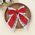 Detailed texture of red satin and floral lace layers on the spring hair clip - Red