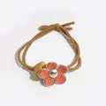 Elegant elastic flower hair tie with brown cord and red floral charm in minimalist style - Orange