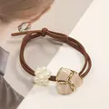 Brown elastic hair tie with white faux pearls and a geometric gold-trimmed resin charm - Beige Triangle Stone