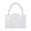 Detailed macro view of white pearlescent acrylic evening bag with beaded handle - White