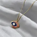 Detail of evil eye pendant with blue enamel, red eyelashes, and a center zircon stone - Blue Red Contrast (ADD-202G-2)