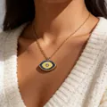 Close-up of golden Evil Eye necklace with enamel details on model collarbone - Dark Blue Light Yellow Contrast (ADD-202G-8)
