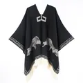 Detailed knit texture of poncho featuring wolf patterns and white fringe tassels - 130x150cm / Wolf Pattern Pullover Tassel (Black)