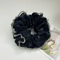 Detail of a black satin scrunchie featuring elegant grey crystal bead trim on fabric - Mesh Large Black