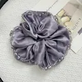 Macro detail of lilac satin scrunchie with beaded edges on a minimalist tray - Satin Large Purple