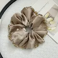 Macro detail of champagne gold satin scrunchie with brown crystal bead trim - Satin Large Khaki
