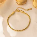 Close-up of golden twist rope bracelet with lobster clasp on silk background - 4MM Gold Bracelet