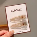 Two-piece clear acrylic hair clip set with silver glitter and gold metal base - Silver Teardrop Hair Clips