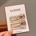 Rectangle acrylic hair clip set with golden base and silver foil inserts on card - White Square Hair Clips