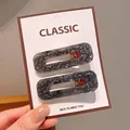 Dark grey translucent acrylic hair clips with silver foil flakes on display card - Square Black Floral Hair Clips
