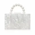 Detail of elegant pearl acrylic clutch with beaded handle and mother of pearl texture - White