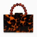 Detail of tortoiseshell acrylic evening bag with amber beaded handle and snap closure - Amber