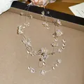 Close-up detail of a crystal flower necklace featuring transparent beads and delicate strings. - White (20#)